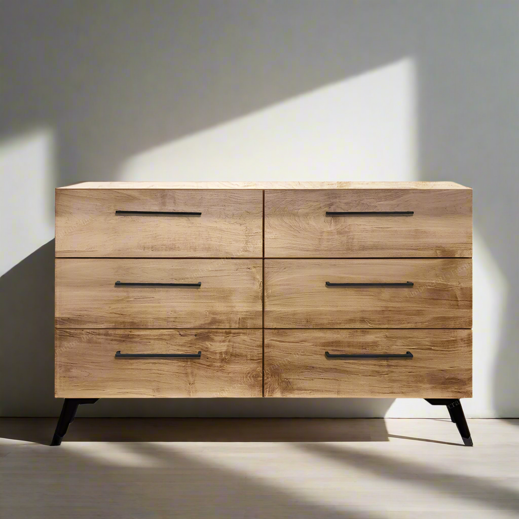 Wooden dresser with four drawers against a neutral wall