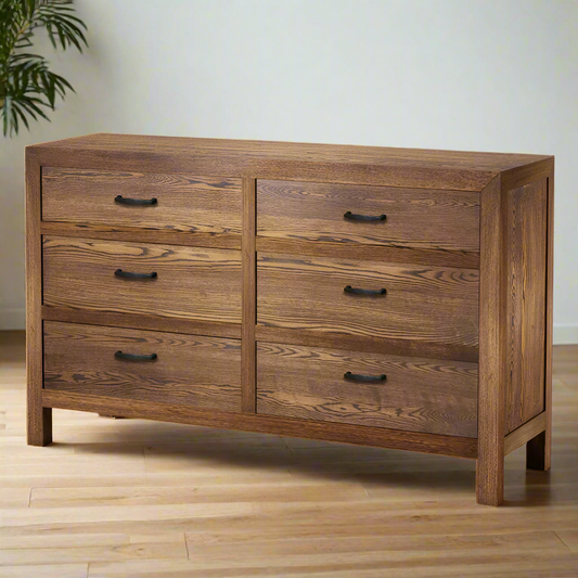 Wooden dresser with four drawers on a white background