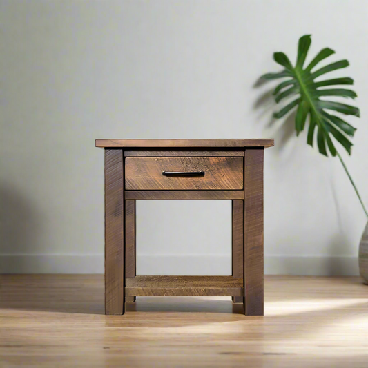 Wooden side table with a drawer on a white background