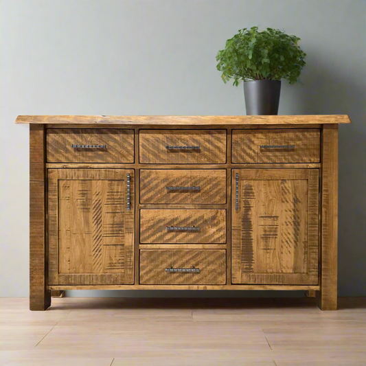 Wooden sideboard with multiple drawers and a door on a white background