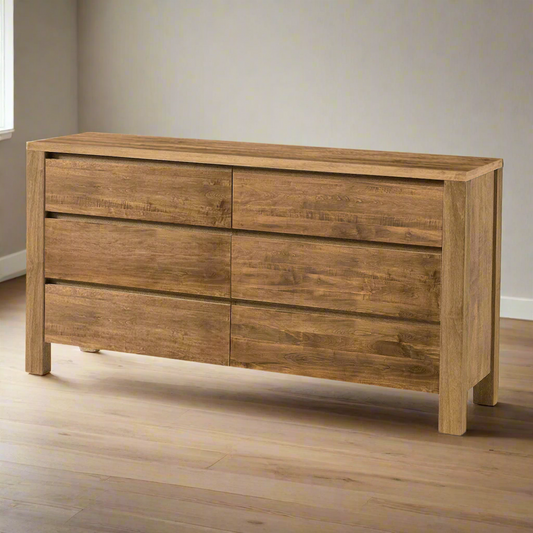 Wooden dresser with four drawers on a white background
