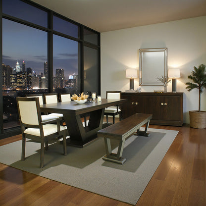 Modern dining room with large windows overlooking a cityscape at night.